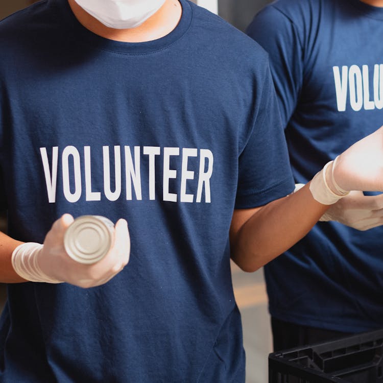 Food bank volunteer handling tinned food