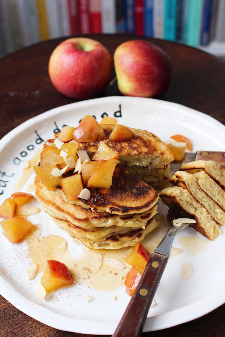 apple pancakes with compote on a white plate