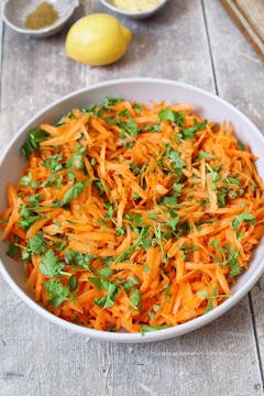 garted carrots and parsley in mixing bowl