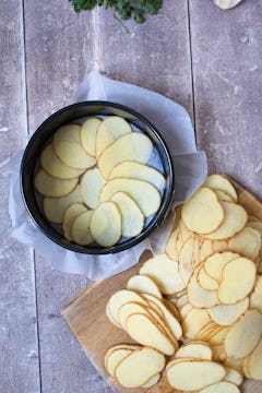 image of sliced potatoes in baking tin