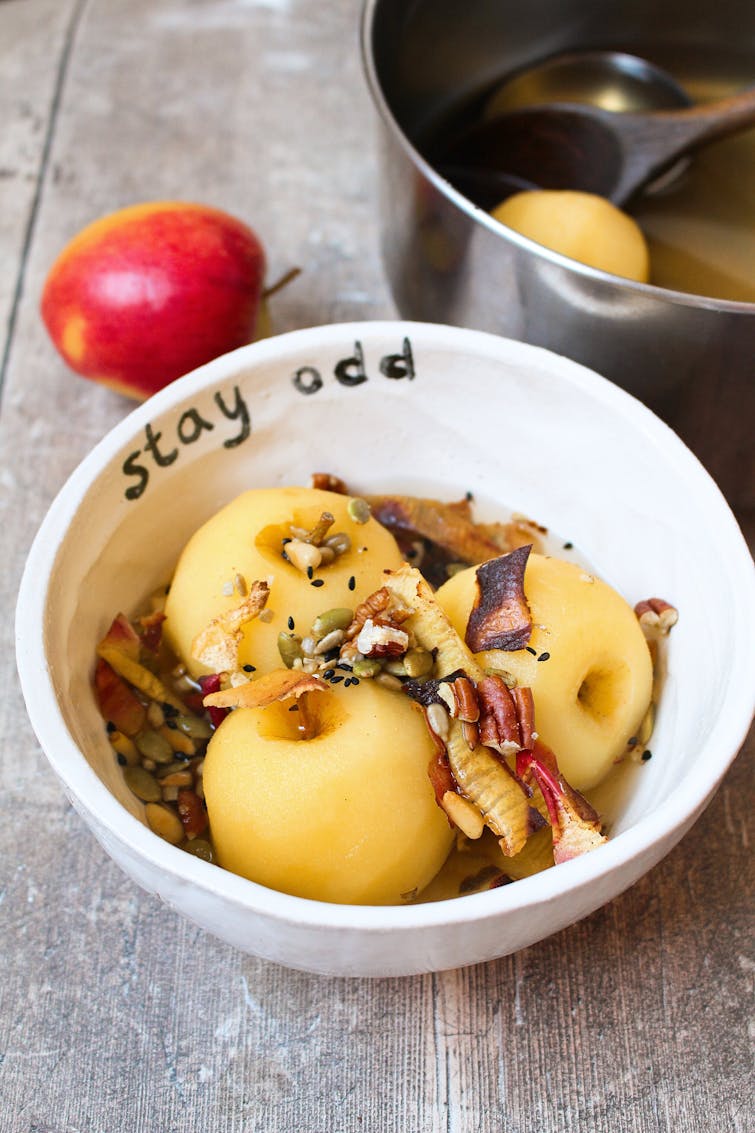 poached apple served with nuts and seed in a bowl
