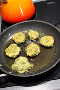 fritters cooking in frying pan
