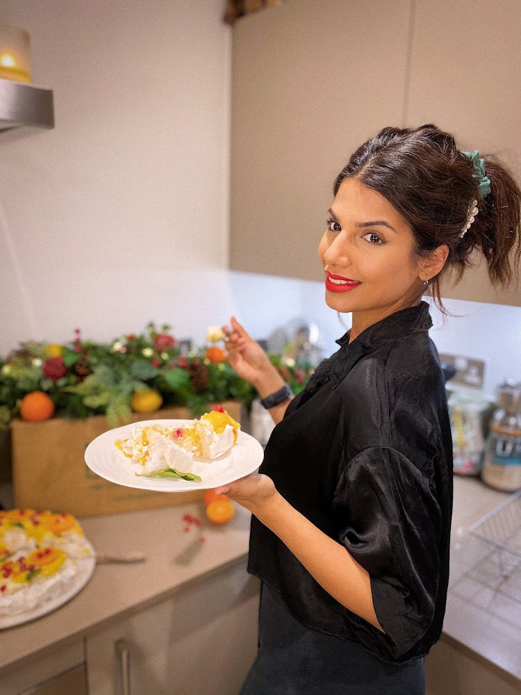 Ruby Bhogal holding a plate of served meringue