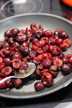 desseded cherry on a frying pan