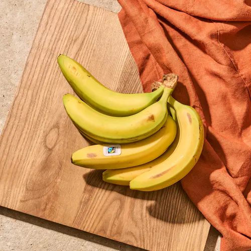 Ripe bananas on a chopping board.