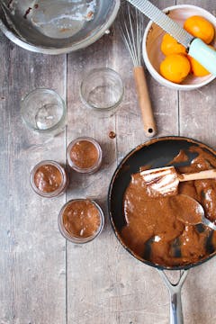3 jars with chocolate mousse mixture, frying pan with the hot mousse mixture 
