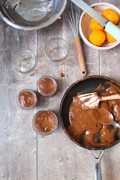 3 jars with chocolate mousse mixture, frying pan with the hot mousse mixture