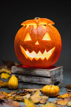 Halloween pumpkin surrounded by mini pumpkins