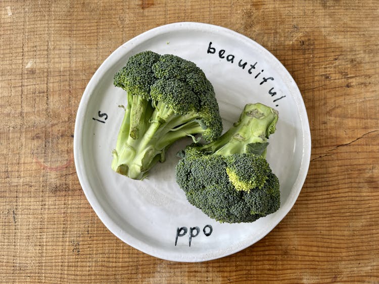 broccoli heads on a white plate 