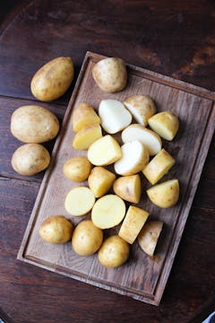 chopped potatoes on chopping board