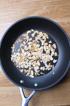 flaked almonds in frying pan 