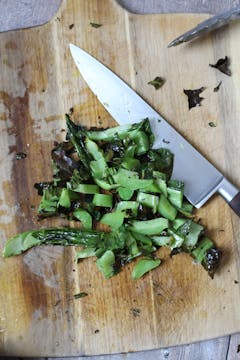 chopped leaves on a chopping board