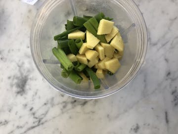 cubed ginger, garlic cloves and spring onions in blender 