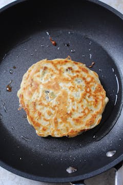 Pancake cooking in frying pan