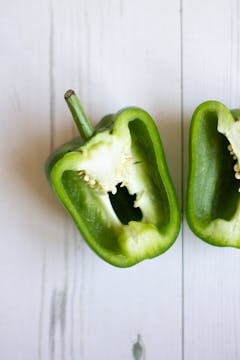 A green capsicum cut into 2 halves