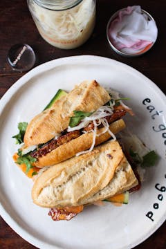 Vietnamese-style grilled tofu vegan sandwich on a white plate