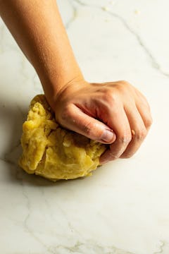 The empanada dough being kneaded. 