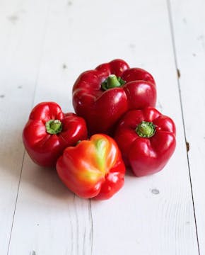 four odd red bell peppers