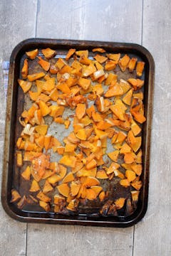 Chopped squash on a baking tray, roasted. 