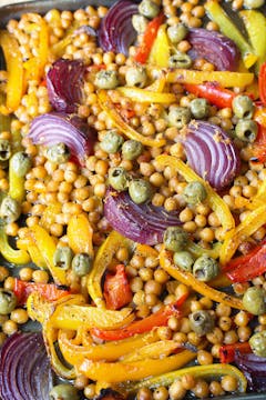 baked chickpeas, red onion and bell peppers on a baking tray