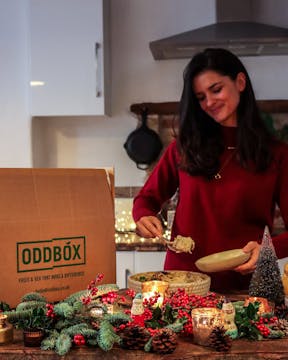 female wearing red jumper serving food