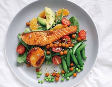 1 piece of salmon dish with colourful veggies 