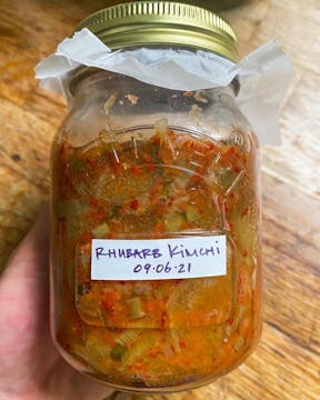 A jar of rhubarb kimchi made by @plantandpickle on Instagram. It's labelled '09.06.21'