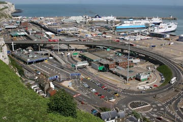 overview image of city road containing vehicles and bridge 