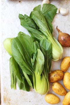 3 pak choi, bunch of baby potatoes with skin and 1 red onion with skin
