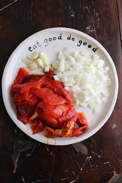 chopped bell peppers, onion and garlic on a plate