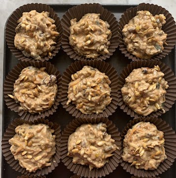 muffin mixture poured into cupcake tray ready to be baked