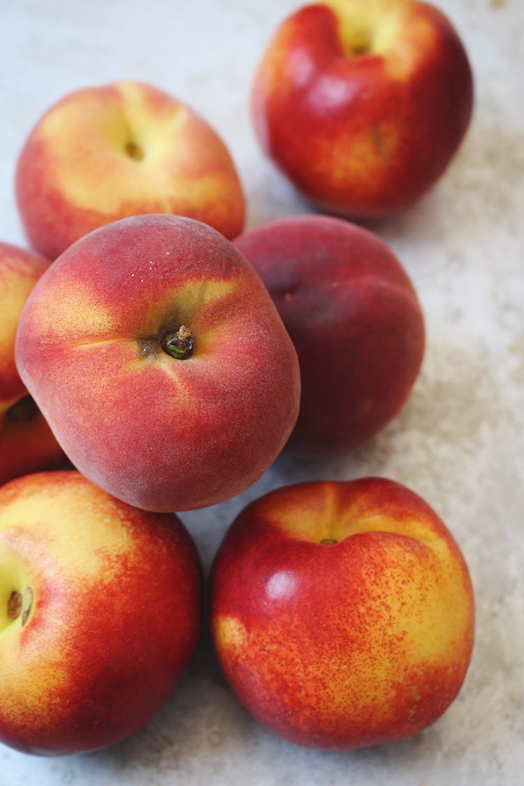 pile of peaches on a stone table