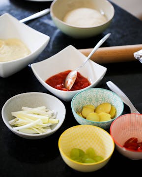 pizza toppings in separate bowls