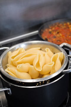 cooked conchiglioni pasta on a colander  