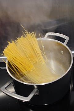 spaghetti in a saucepan with boiling salted water