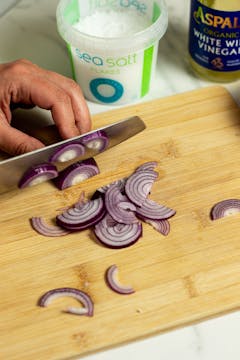 Red onions getting chopped finely