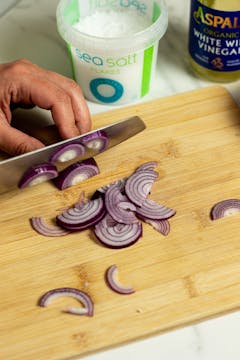 Red onions getting chopped finely 