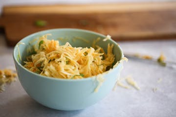 image of bowl with grated potato egg and flour