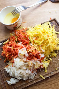 grated carrots on chopping board 