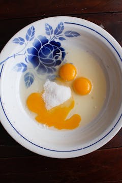 cracked egg and sugar in a bowl