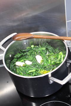 cavolo nero in the process of getting boiled with other ingredients