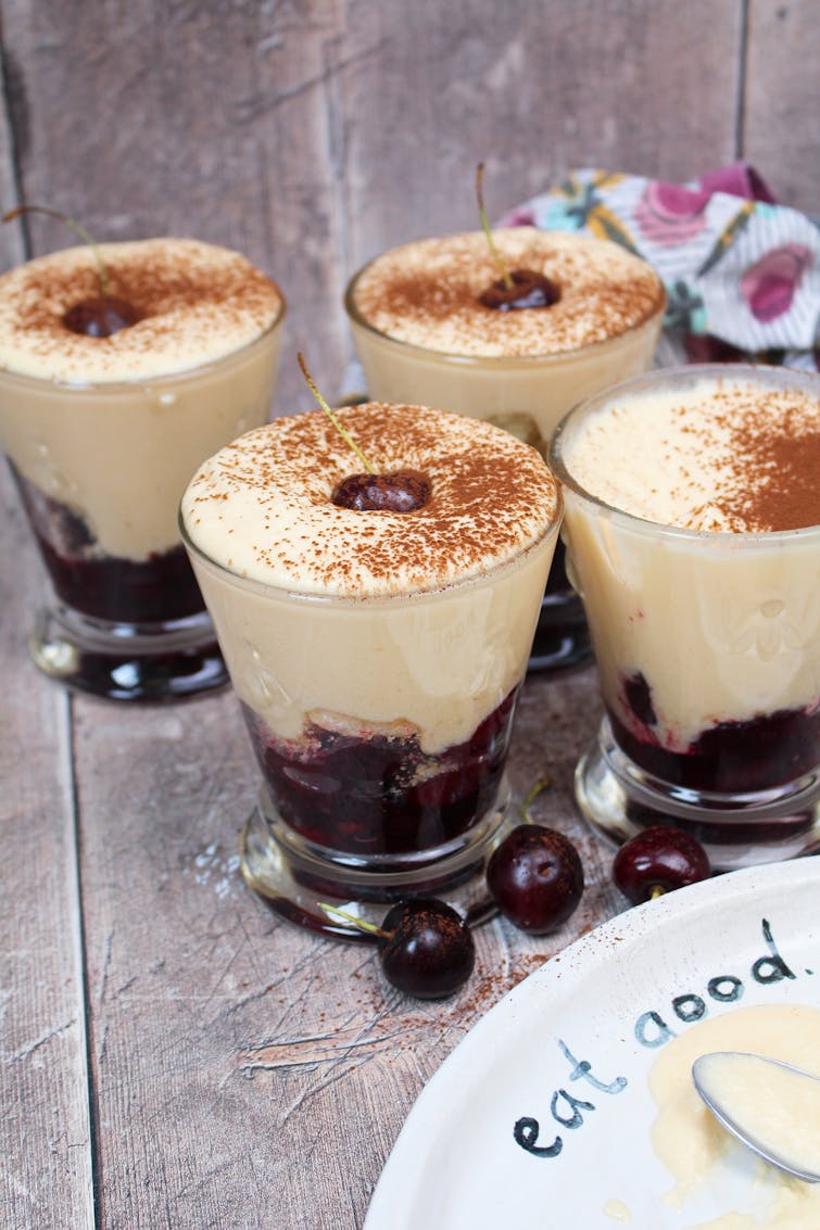 Fruity tiramisu topped with fresh cherry and cocoa powder