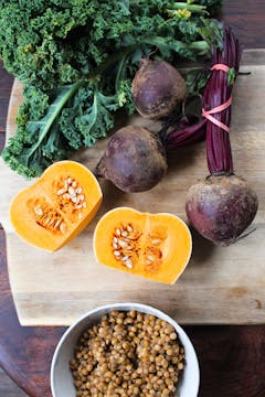 pumpkin, beetroot and kale on a chopping board