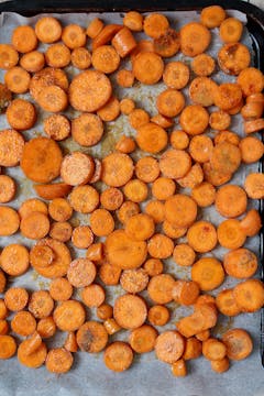 sliced seasoned carrot on a baking tray