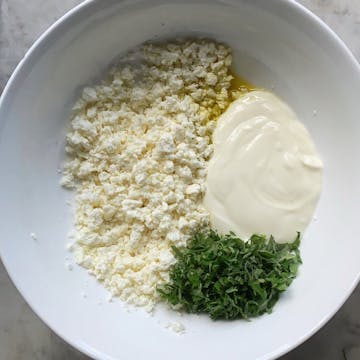 all the ingredients for feta whip in a bowl