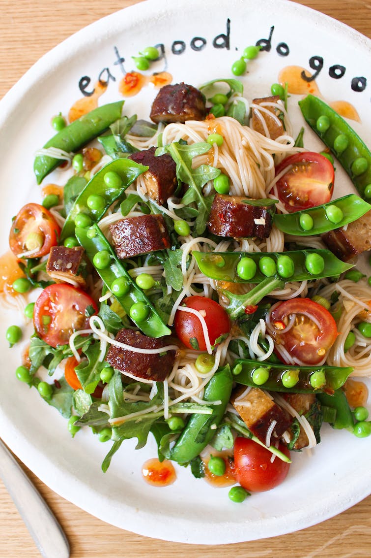 Vietnamese-inspired pea, tofu and noodle salad on a white plate