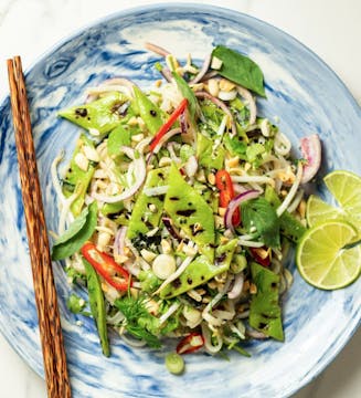 noodles on a blue plate with wooden chopsticks