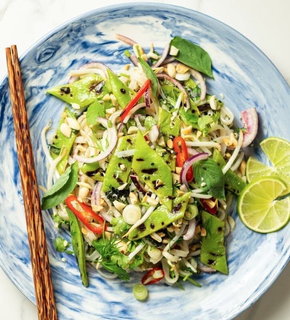noodles on a blue plate with wooden chopsticks