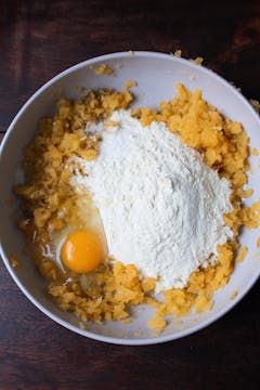 swede, egg and flour in mixing bowl