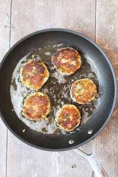 5 potato cake being cooked in a frying pan